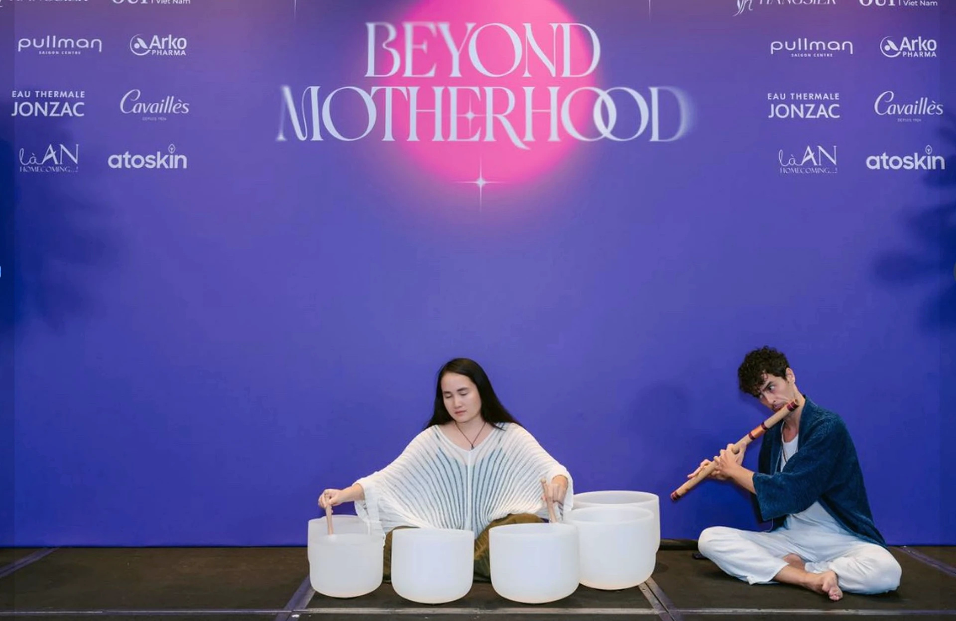 Orçun playing bansuri beside crystal singing bowls at Beyond Motherhood
